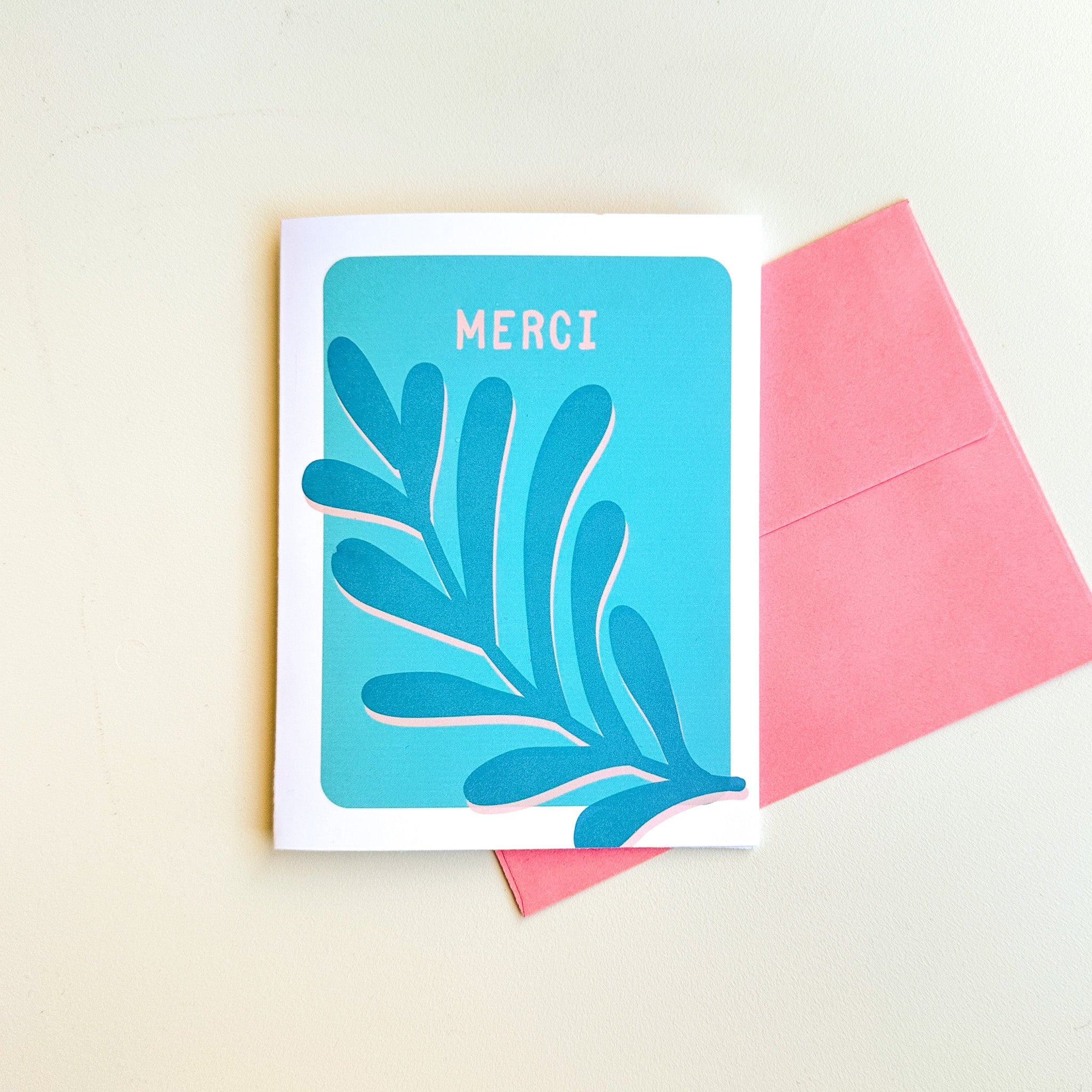 Illustration minimaliste de feuillage délicat entourant le mot Merci en typographie moderne sur fond blanc
